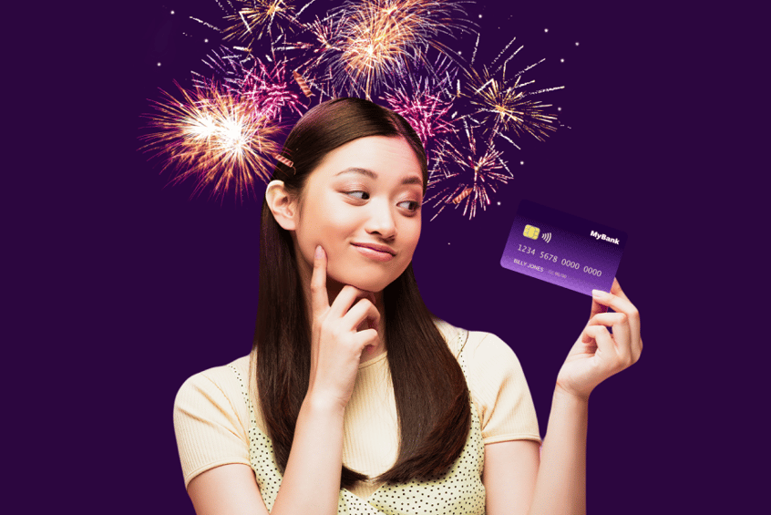 A girl with a purple background and fireworks holding a card