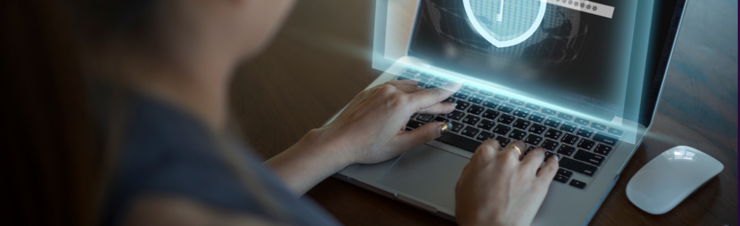 A woman typing on her laptop