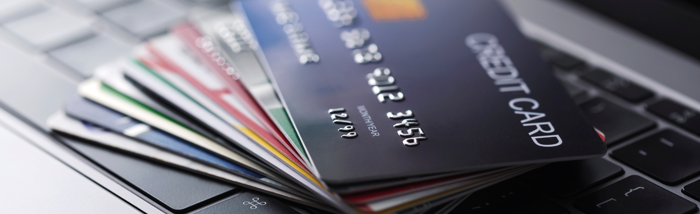 Stack of credit cards on a laptop