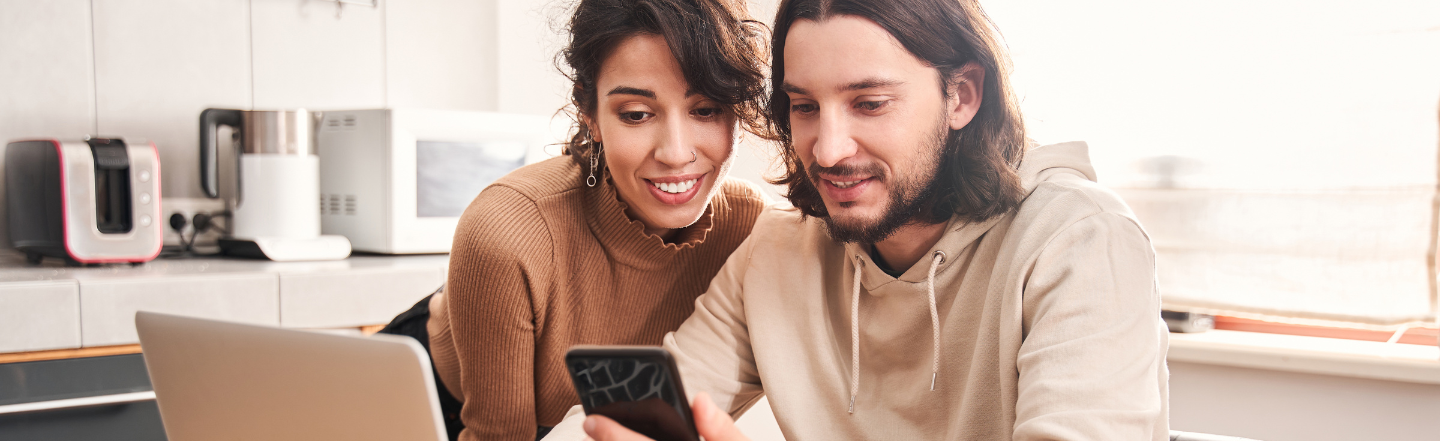 Couple looking at phone.