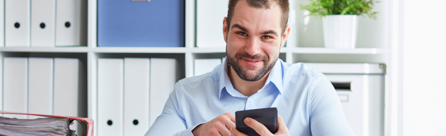 Man with a calculator preparing to lodge his tax return