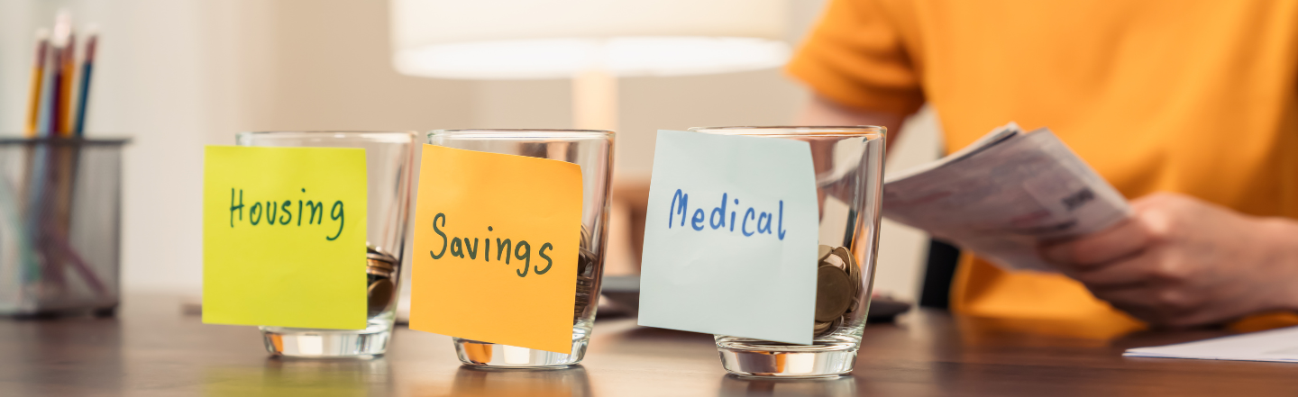 Jars of savings with labels housing, savings and medical