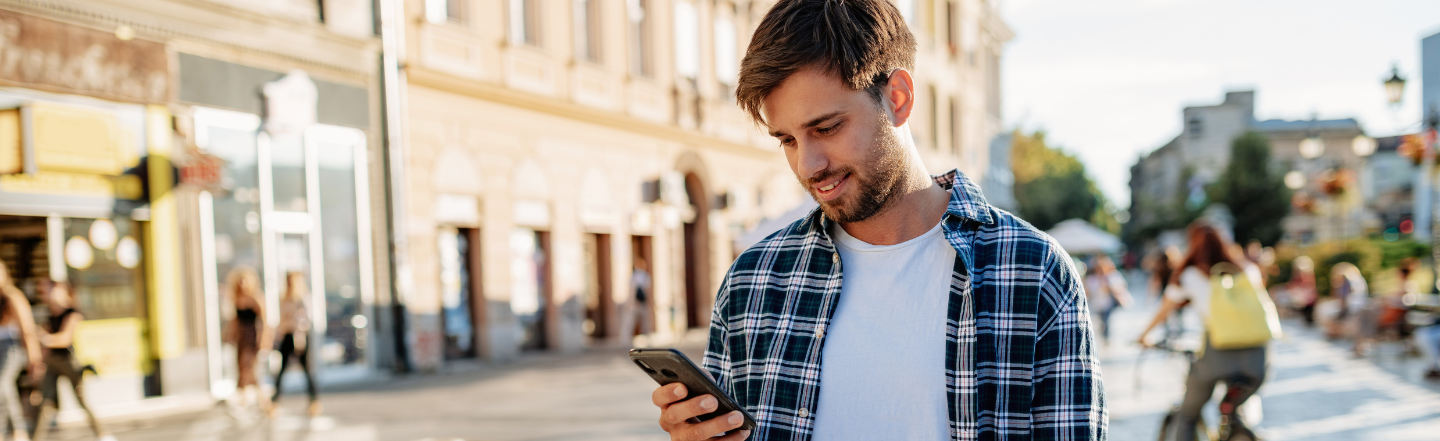 Young adult male holding phone