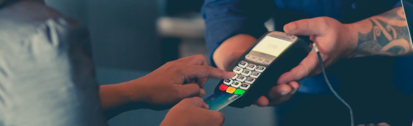 Person paying with credit card on EFTPOS machine
