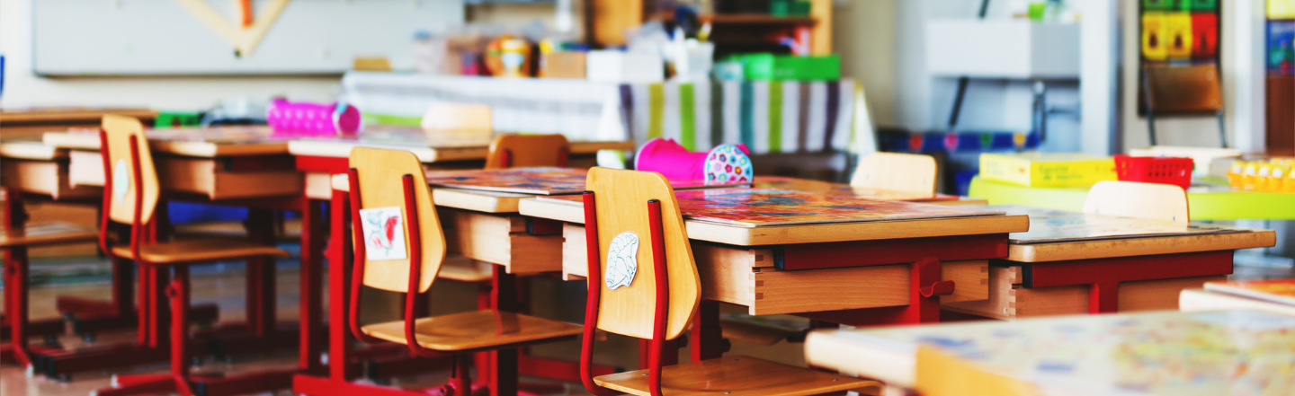 Back to school image with tables and chairs with stationery 