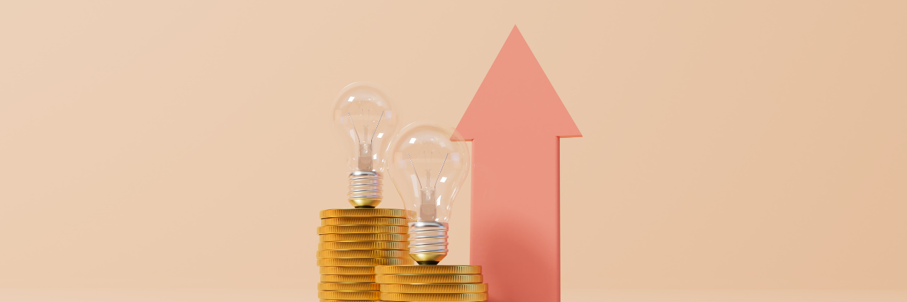 Light bulb standing on gold coins in front of a red arrow pointing up to signify utility spending increase of 4.8% month-on-month as energy price hikes approach, according to the Beforepay Cost of Living Index.