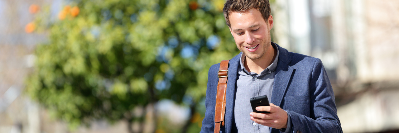 Man in blazer holding phone