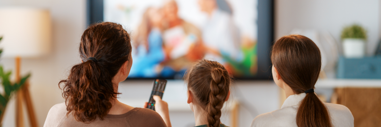 Family enjoying a weekend watching TV together.